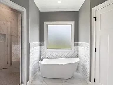 Freestanding Tub Herringbone Tile Bathroom Remodel Okc project in Edmond, OK and the greater Oklahoma City metro