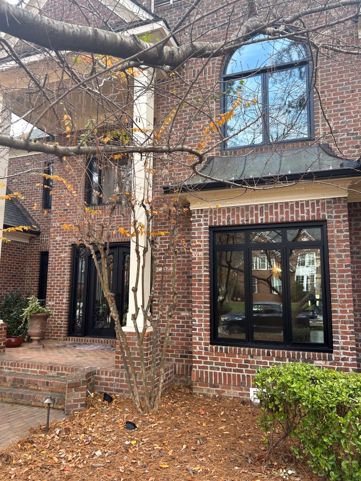 Arched Black Frame Windows Brick Facade