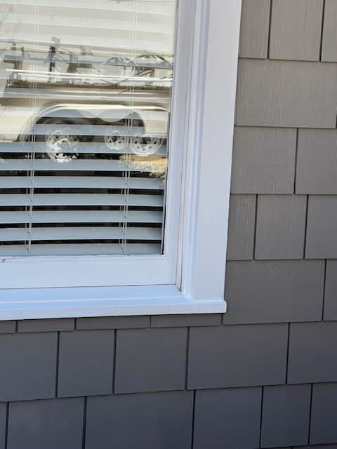 Close Up White Window Frame Gray Shake Siding