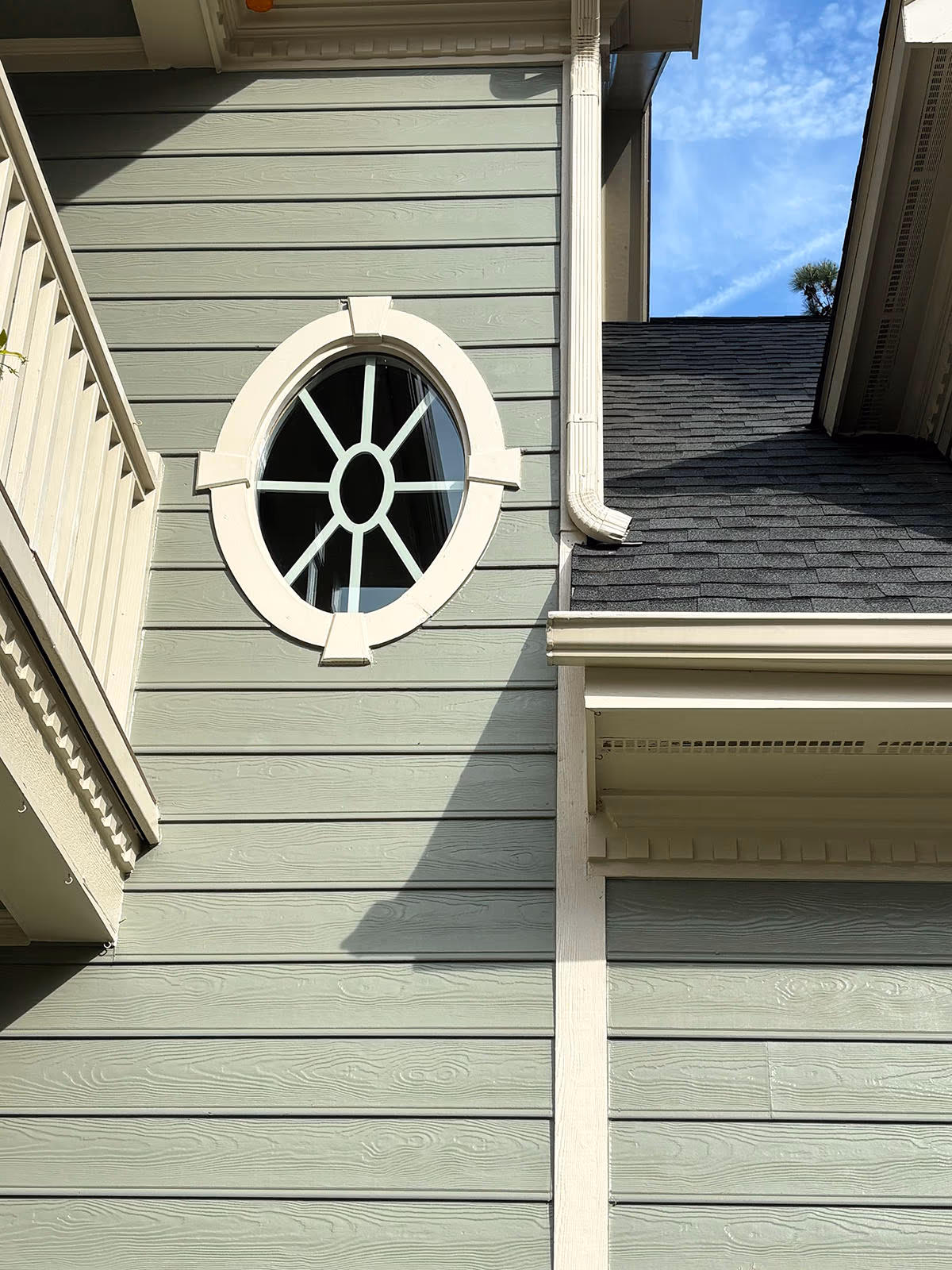 Oval Spoke Window Gray Siding Exterior