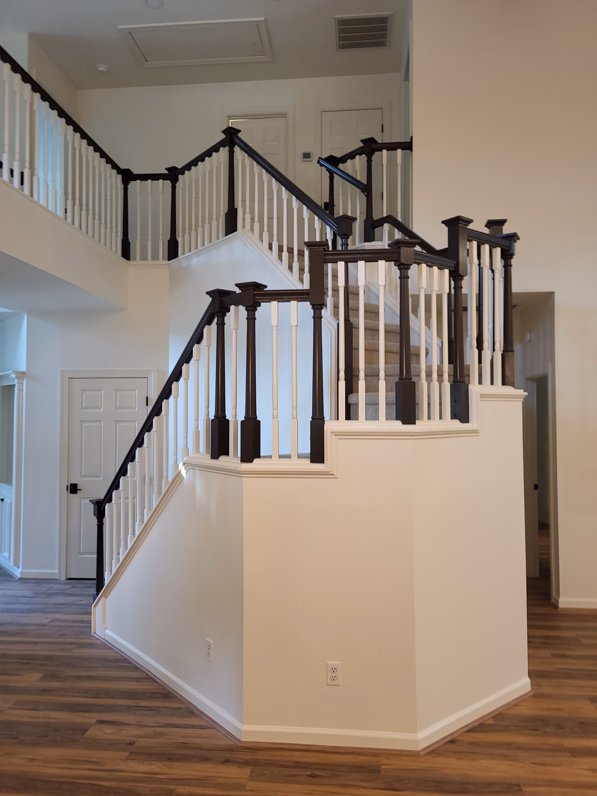 Two Story Foyer Staircase Dark Rail White Balusters