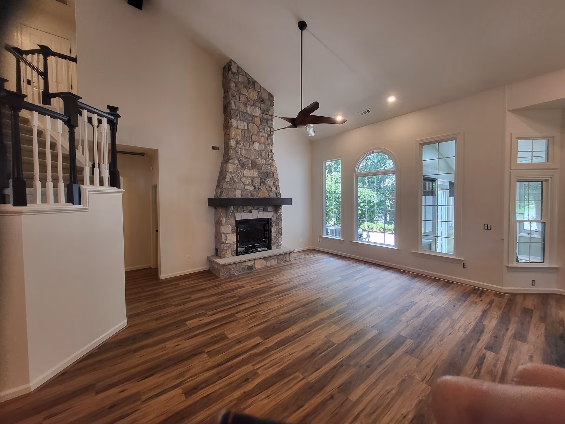 Vaulted Great Room Arched Windows Stone Fireplace